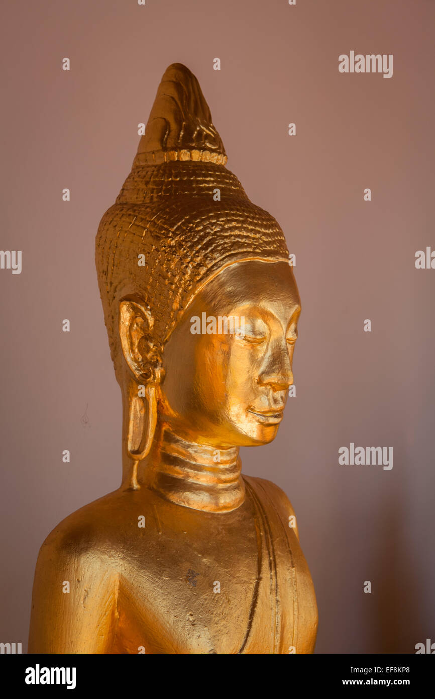 Golden Buddha sculpture at veranda of Wat Phra Boromathat Chaiya, Surat Thani, Thailand. Stock Photo