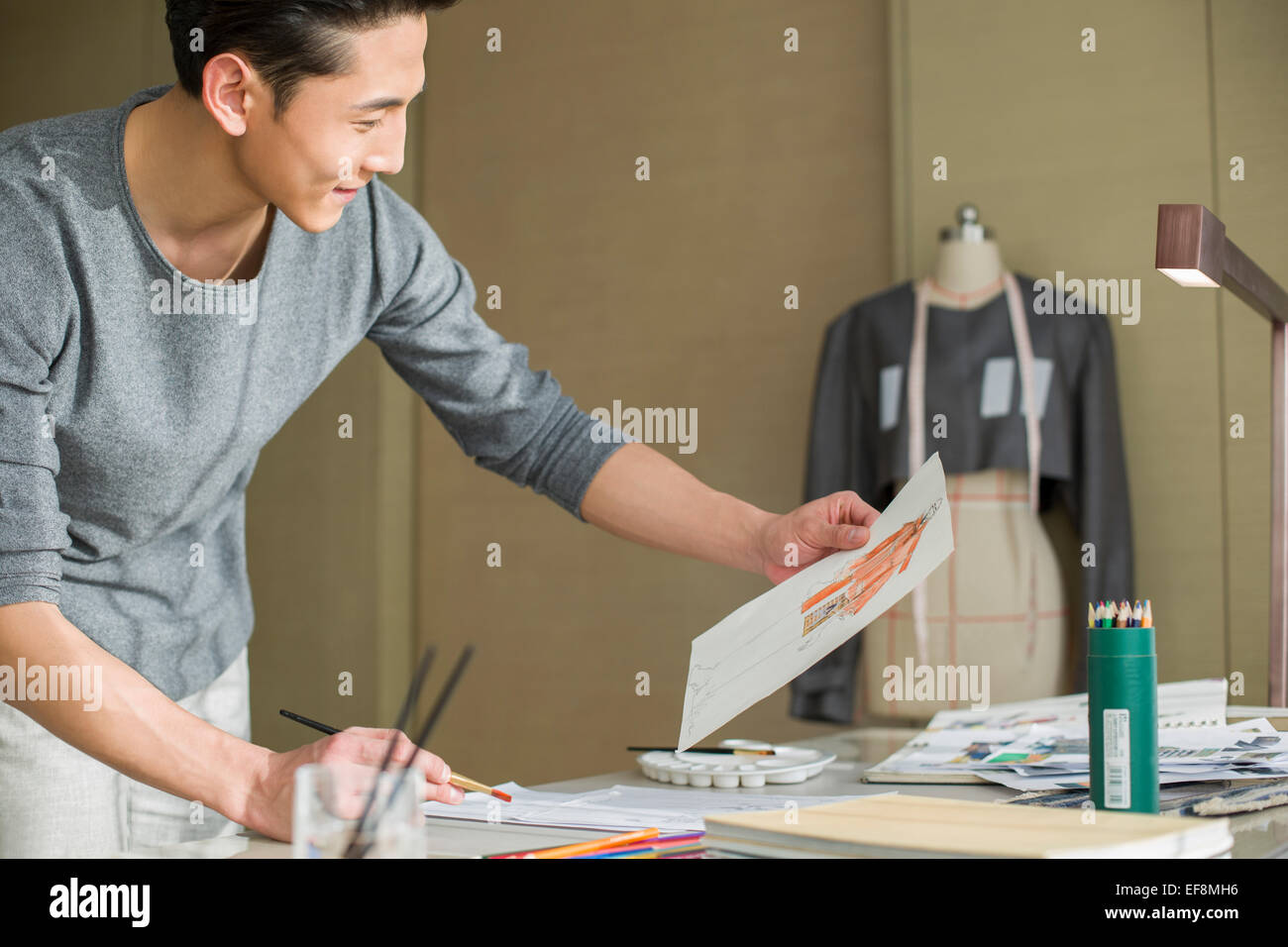 Fashion designer drawing sketch Stock Photo - Alamy