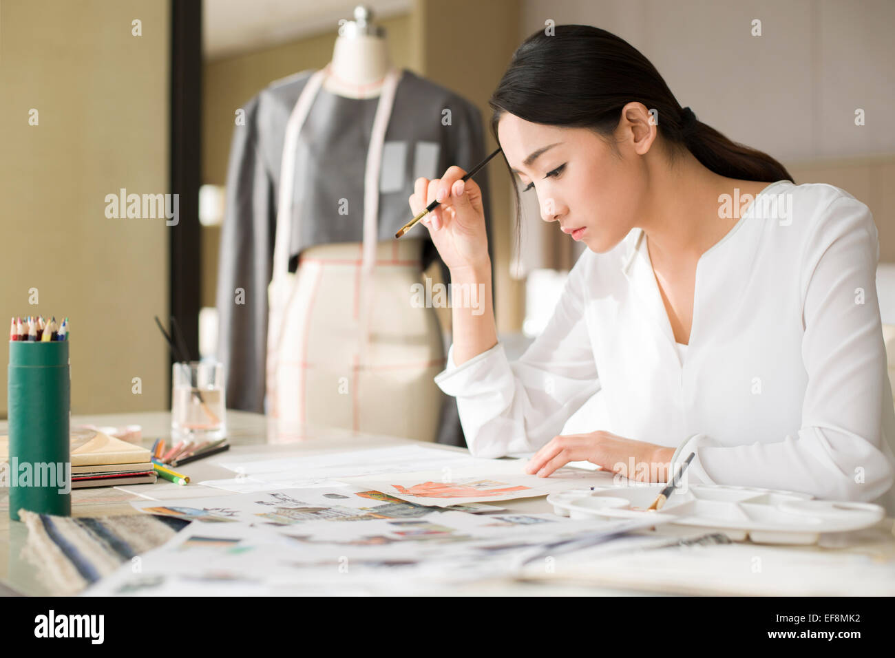 Fashion designer drawing sketch Stock Photo - Alamy