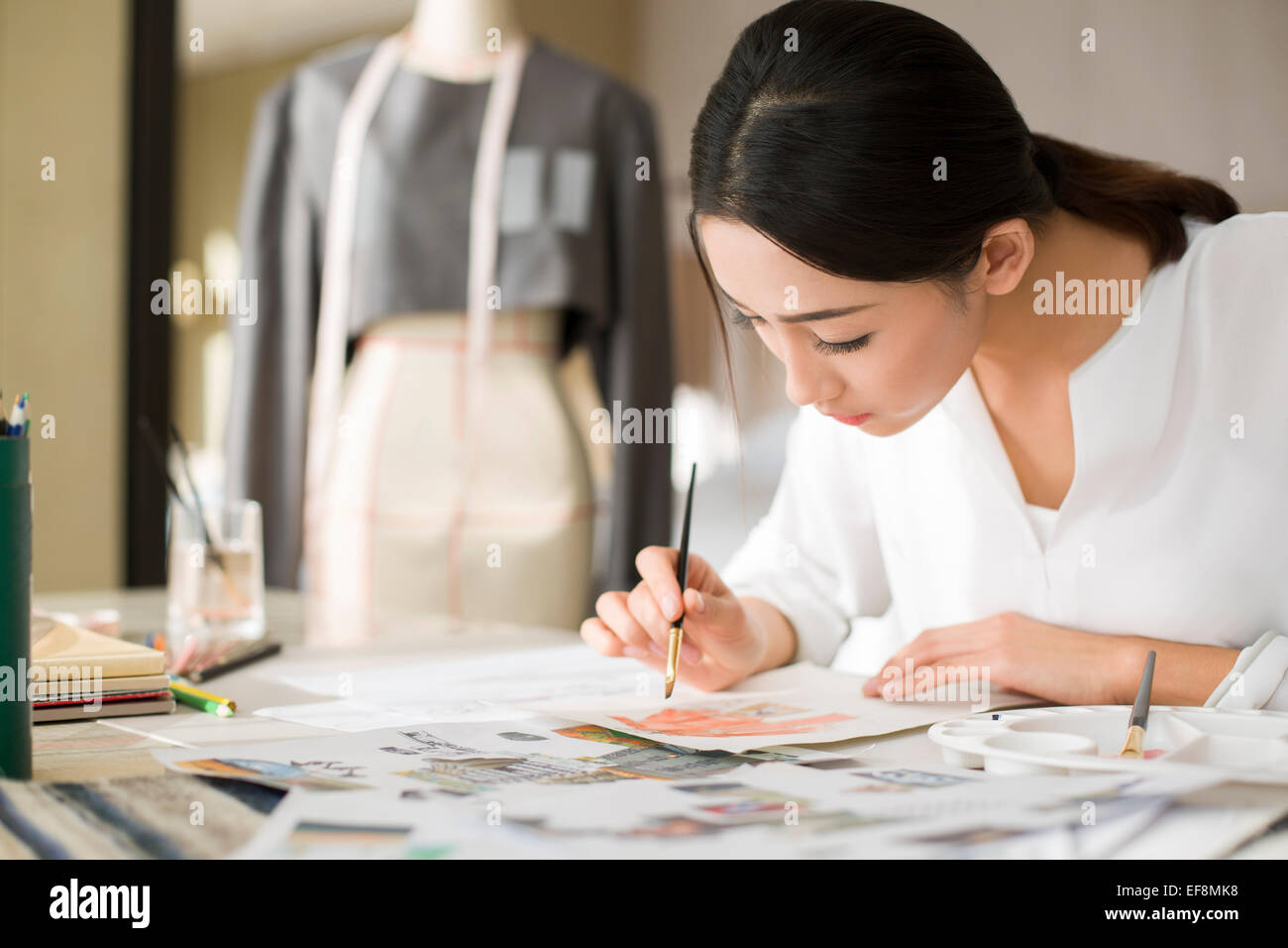 Fashion designer drawing sketch Stock Photo - Alamy