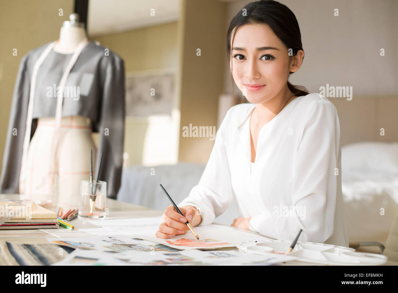 Fashion designer drawing sketch Stock Photo - Alamy