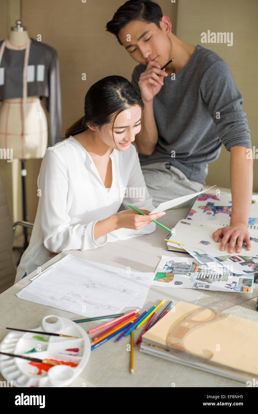 Two fashion designers drawing sketch Stock Photo - Alamy