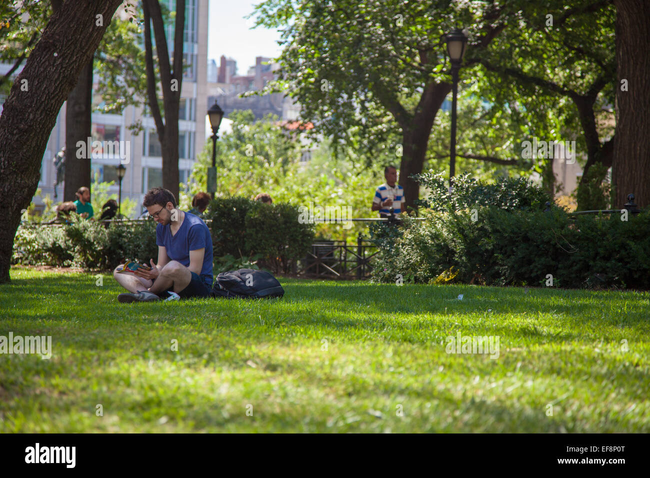 People resting in Union Square Park, New York City Stock Photo