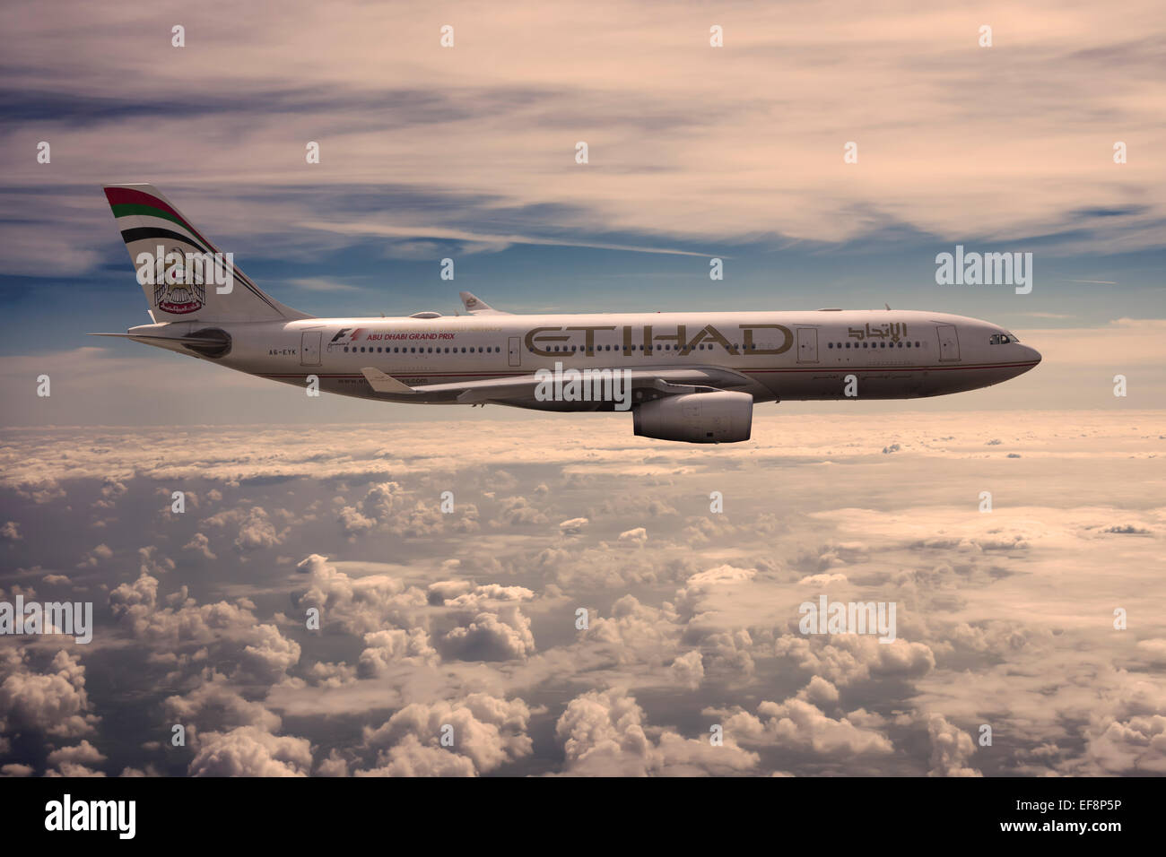 A6-EYK Etihad Airways Airbus A330-243 in flight above the clouds in the evening light Stock Photo
