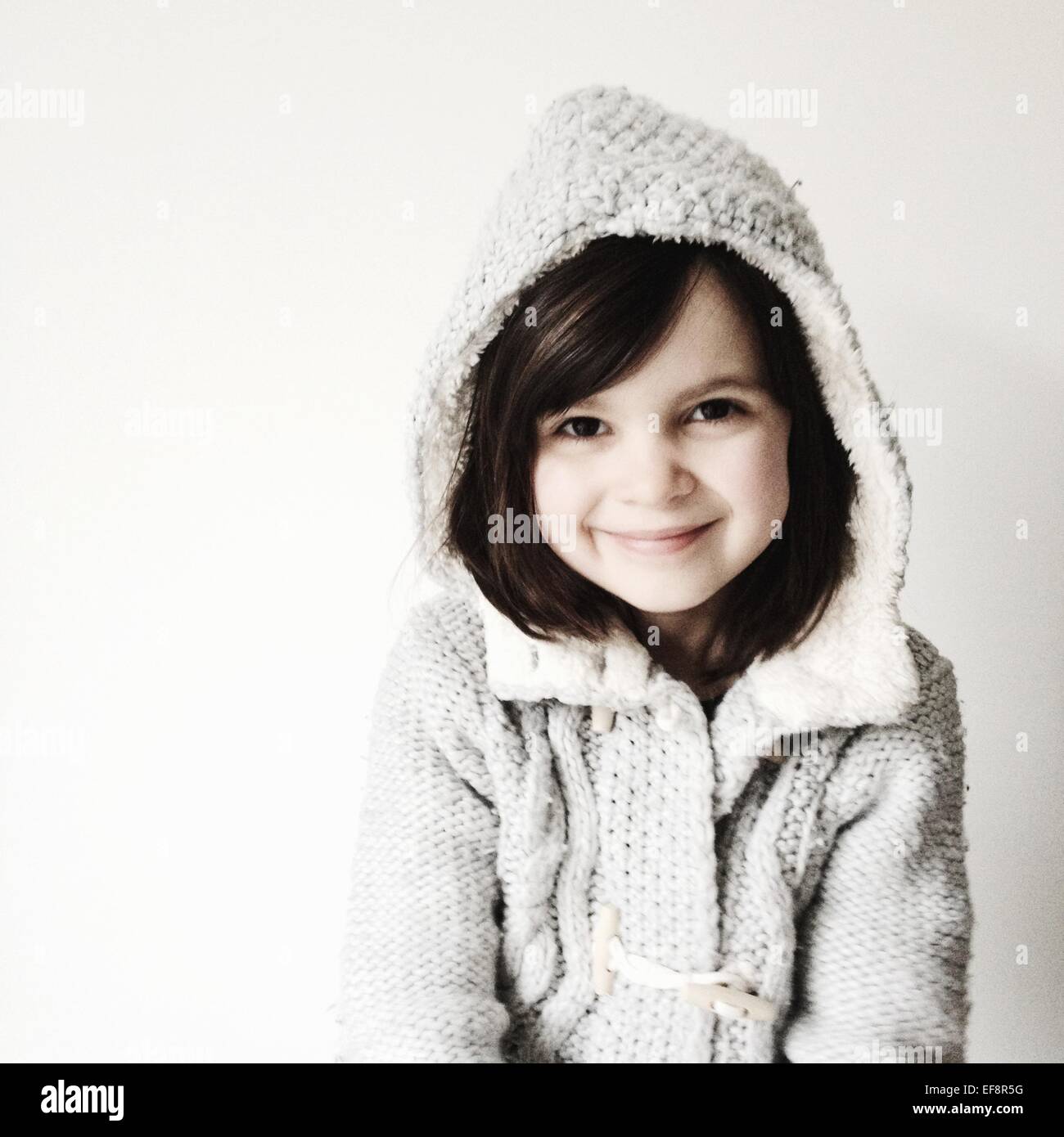 Portrait of smiling girl wearing hooded sweater Stock Photo Alamy