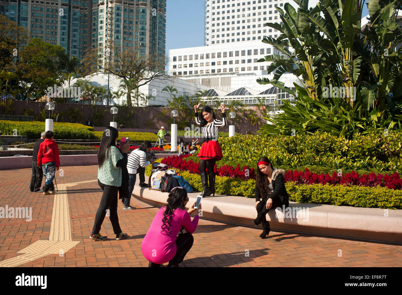 Hong Kong 2015  - Filipino women enjoying a sunny day at Victoria park in Kowloon Stock Photo