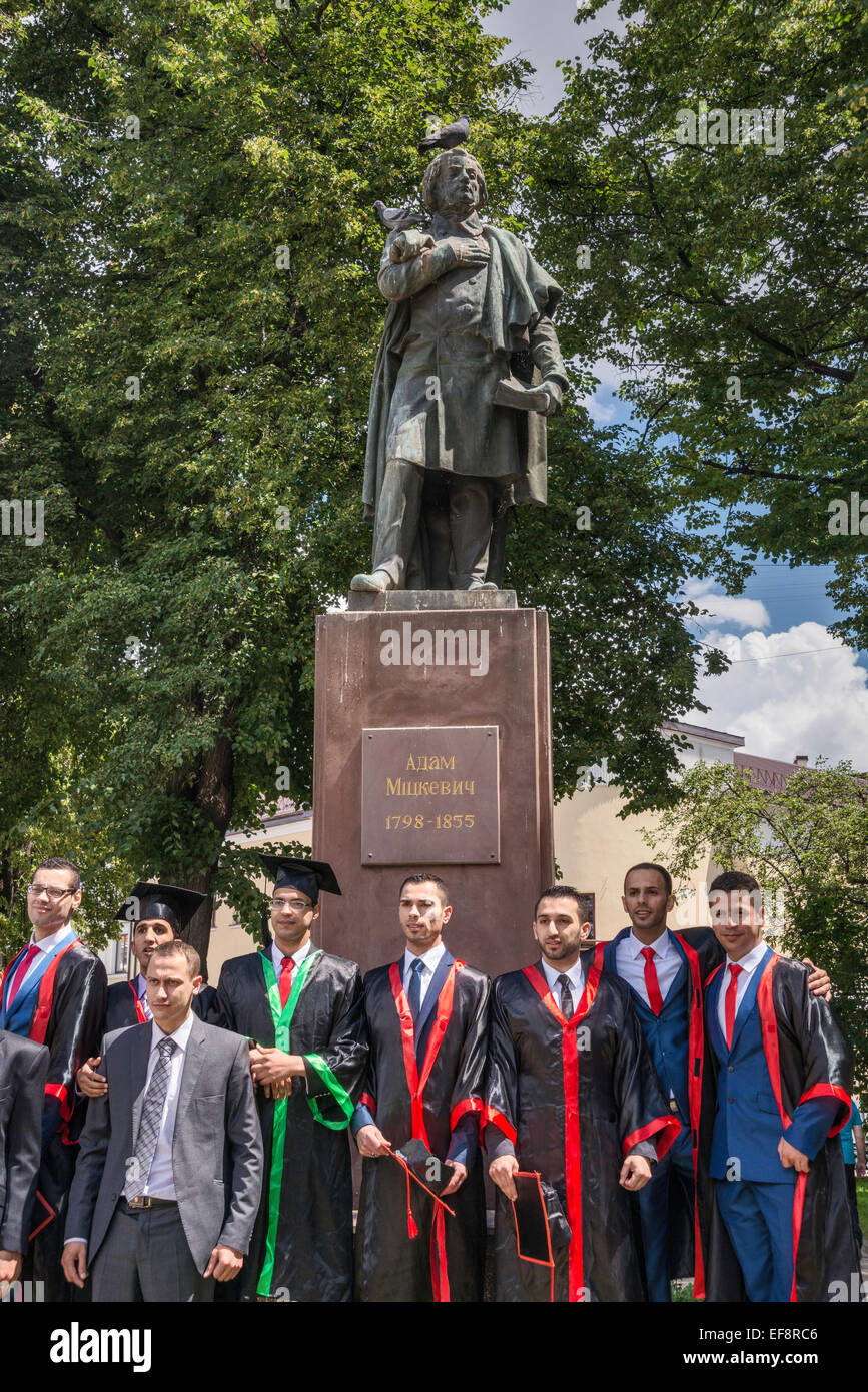 Arab students, Medical University graduates, at statue of Polish poet Adam Mickiewicz, in Ivano-Frankivsk, Ukraine Stock Photo