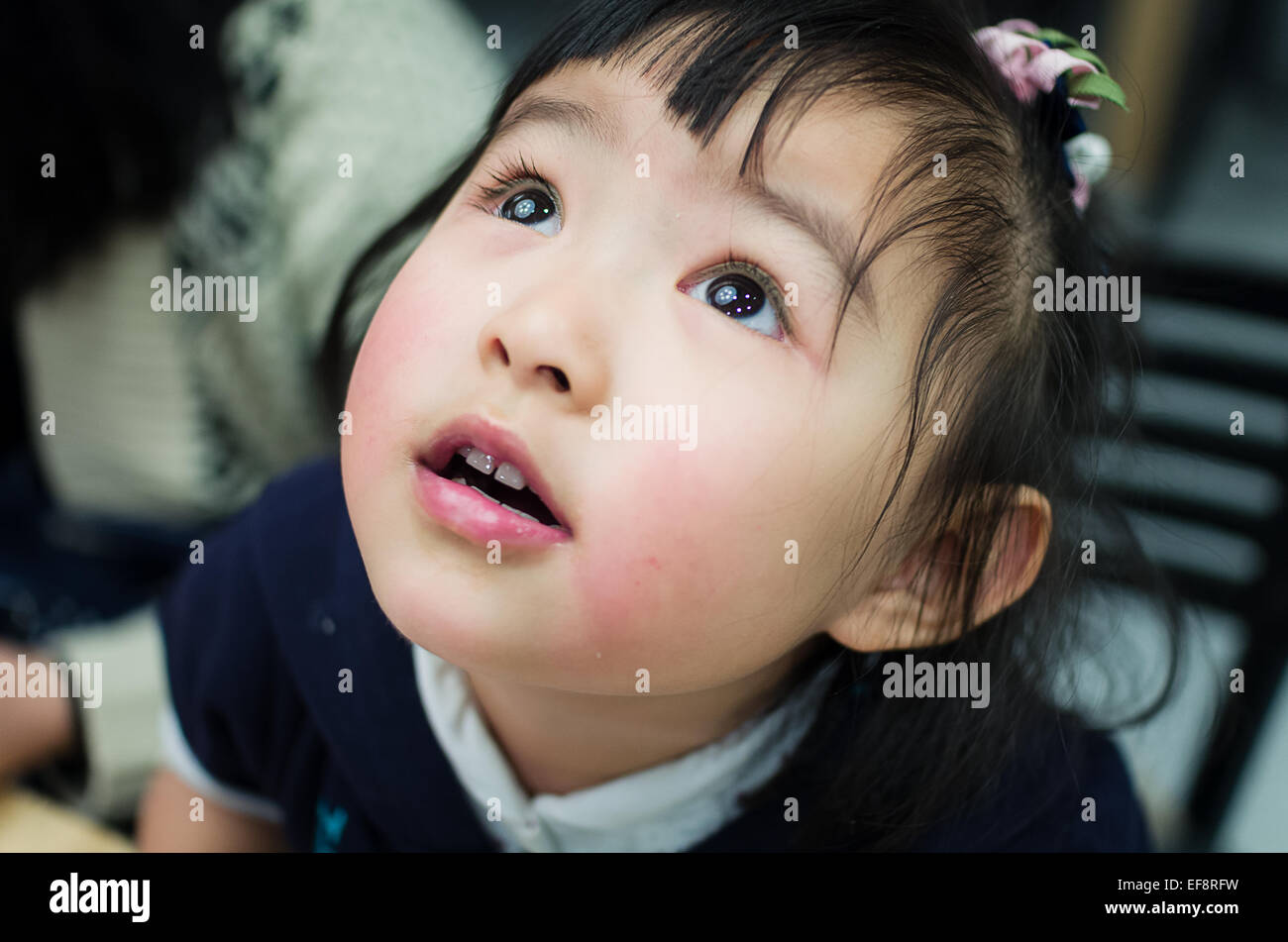 Australia Melbourne Headshot Of Young Girl Looking Up Stock