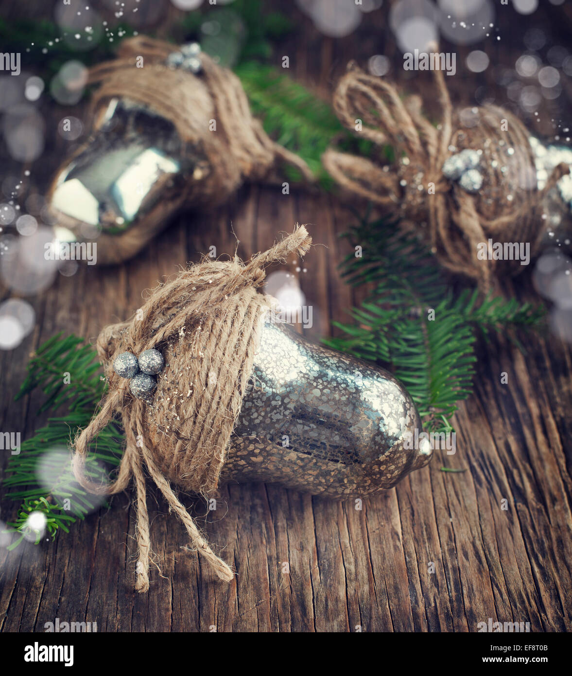 Silver-colored Christmas baubles on wooden surface Stock Photo