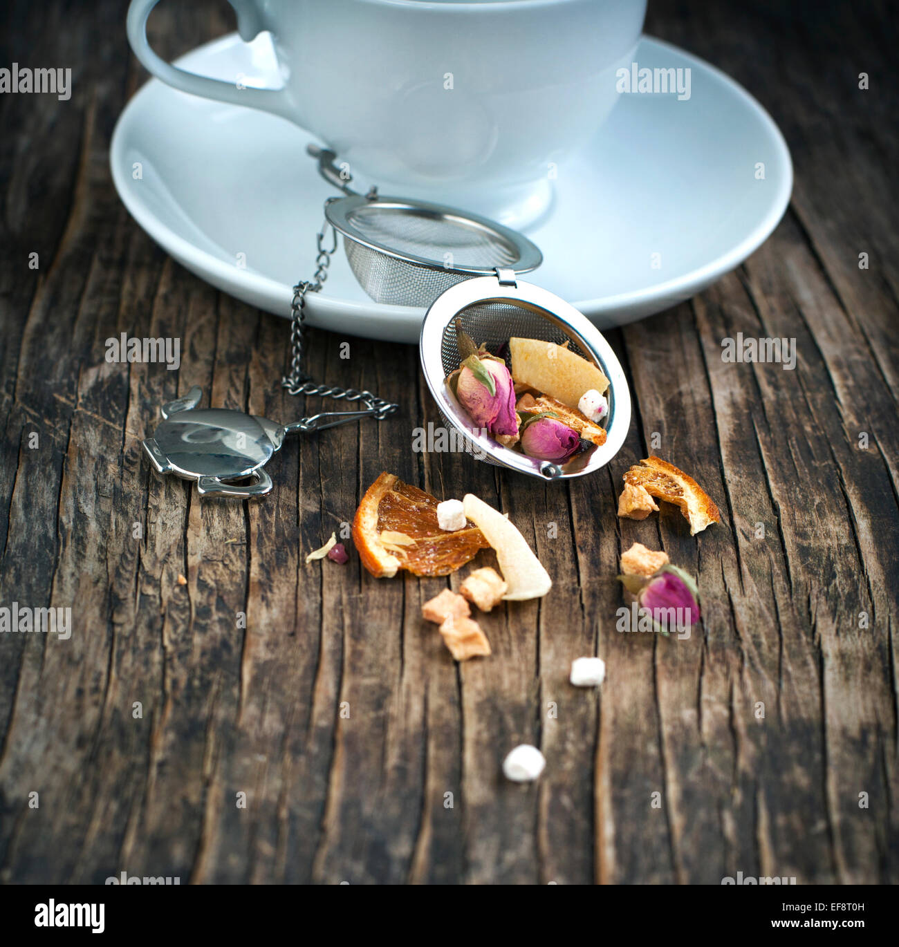 Cup of tea and tea strainer with marshmallow macaron herbal tea Stock Photo