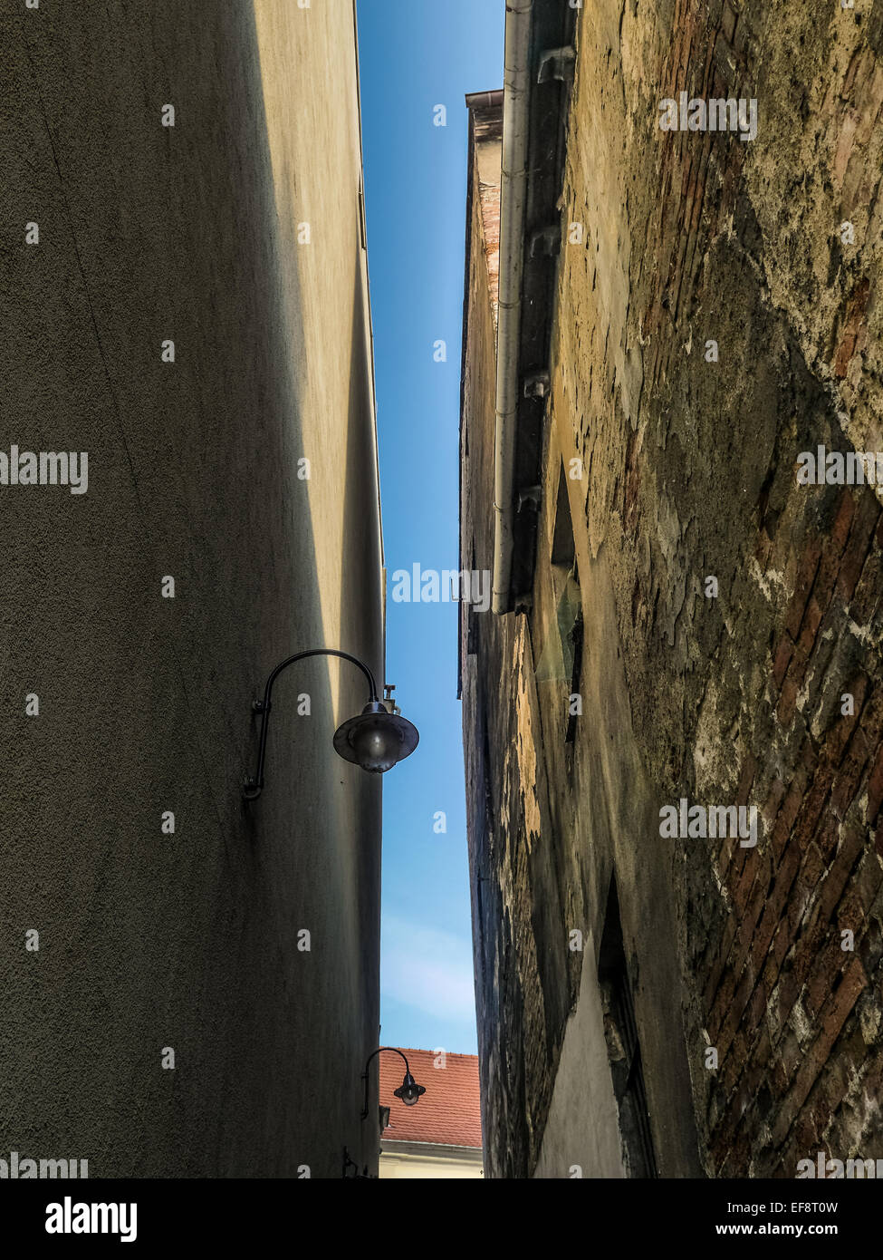 Two adjacent townhouse walls making narrow passage Stock Photo
