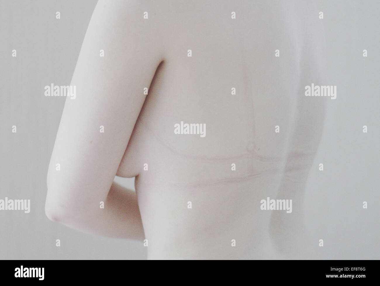 Close-up of a naked woman with bra marks on her back Stock Photo