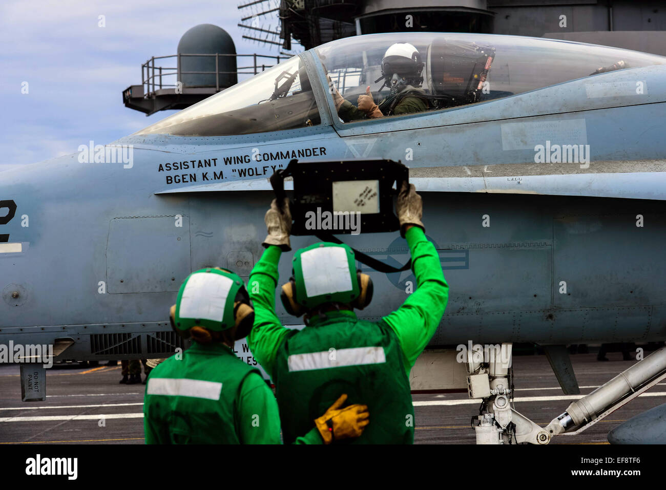 A US Navy pilot confirms the weight of his F/A-18 Hornet fighter aircraft prior to launch from the flight deck of the nuclear Nimitz-class aircraft carrier USS John C. Stennis January 28, 2015 in the East China Sea. Stock Photo