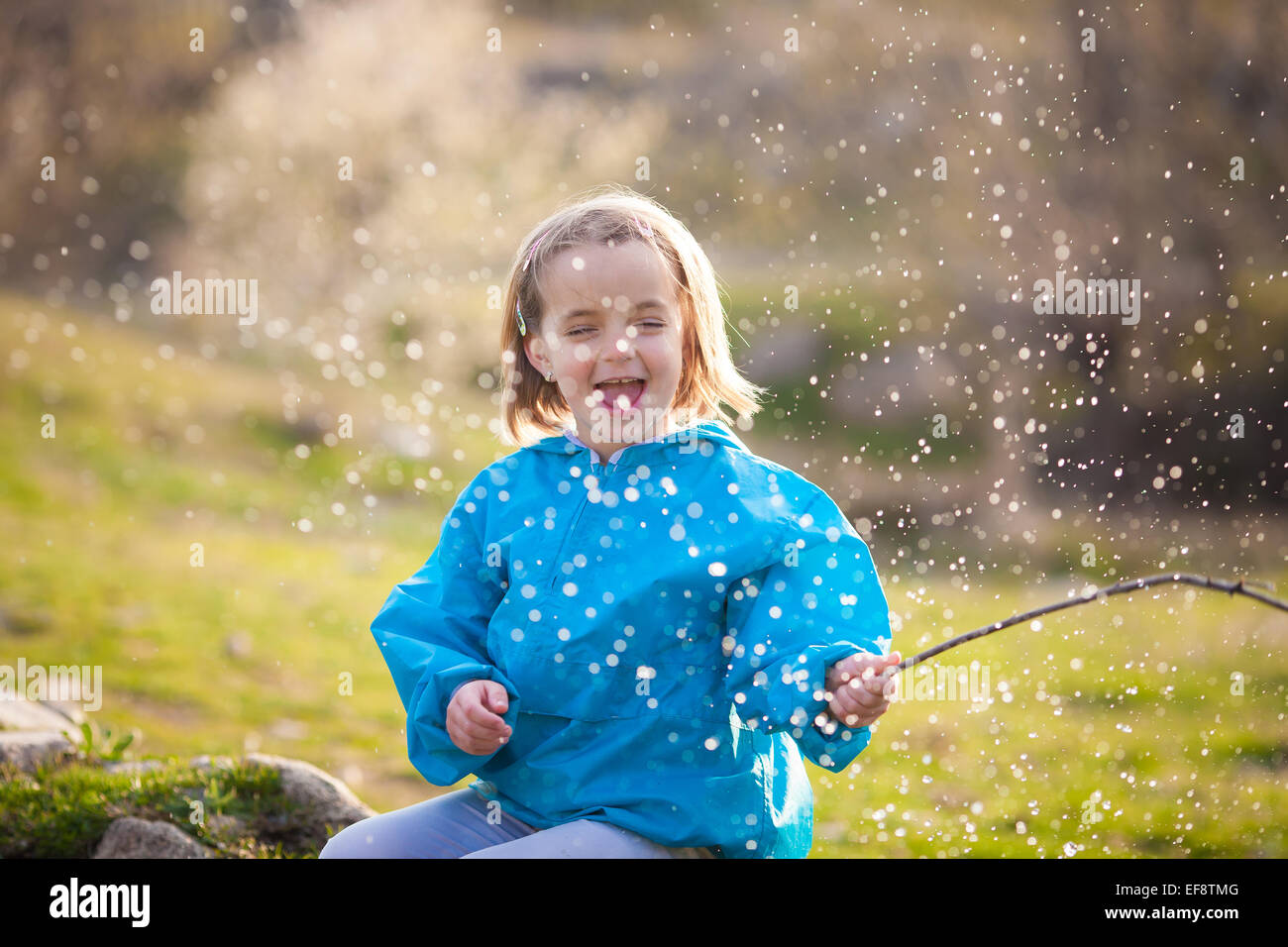 Girl (4-5) playing outdoors Stock Photo