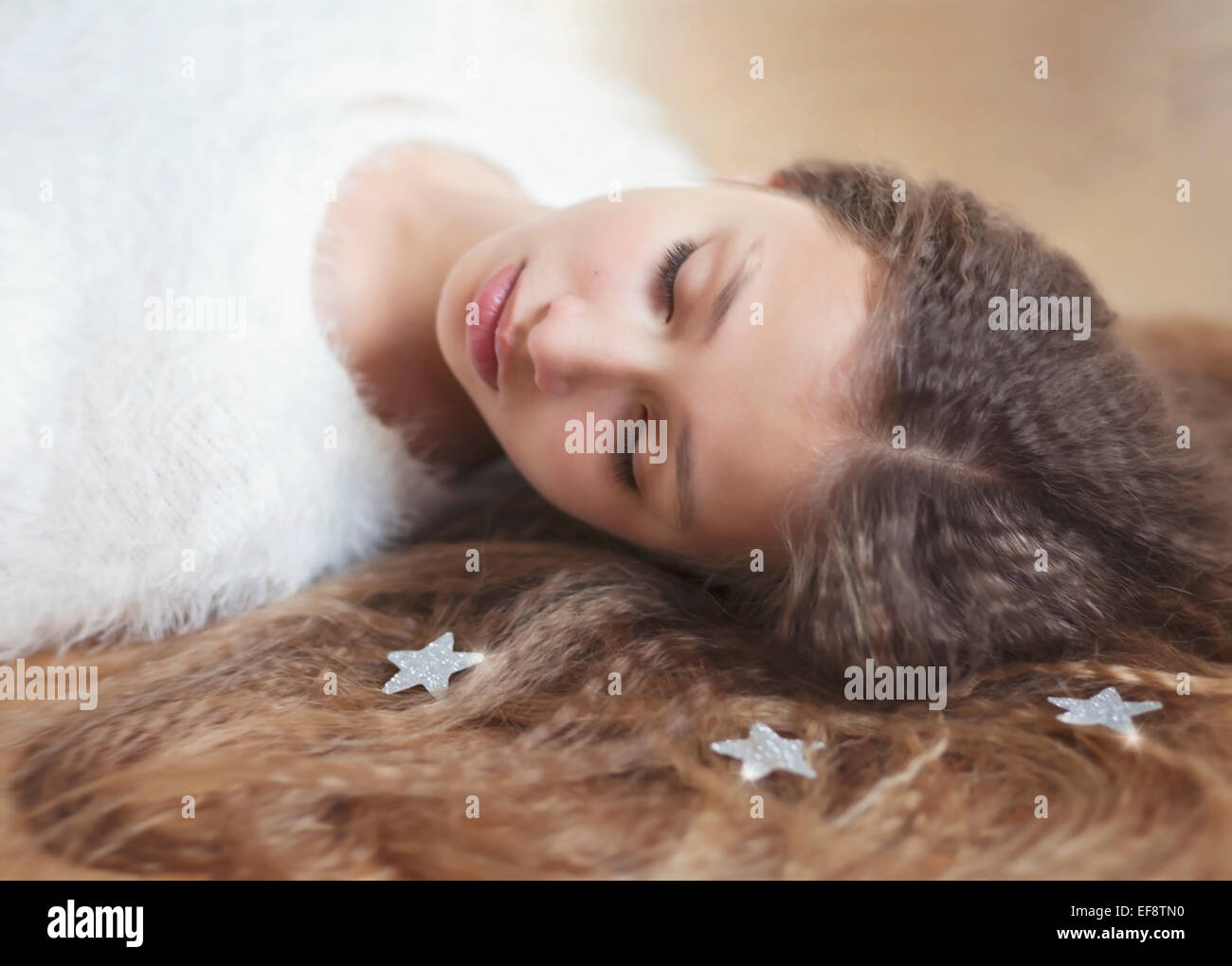 Portrait of girl (12-13) with long hair lying down Stock Photo