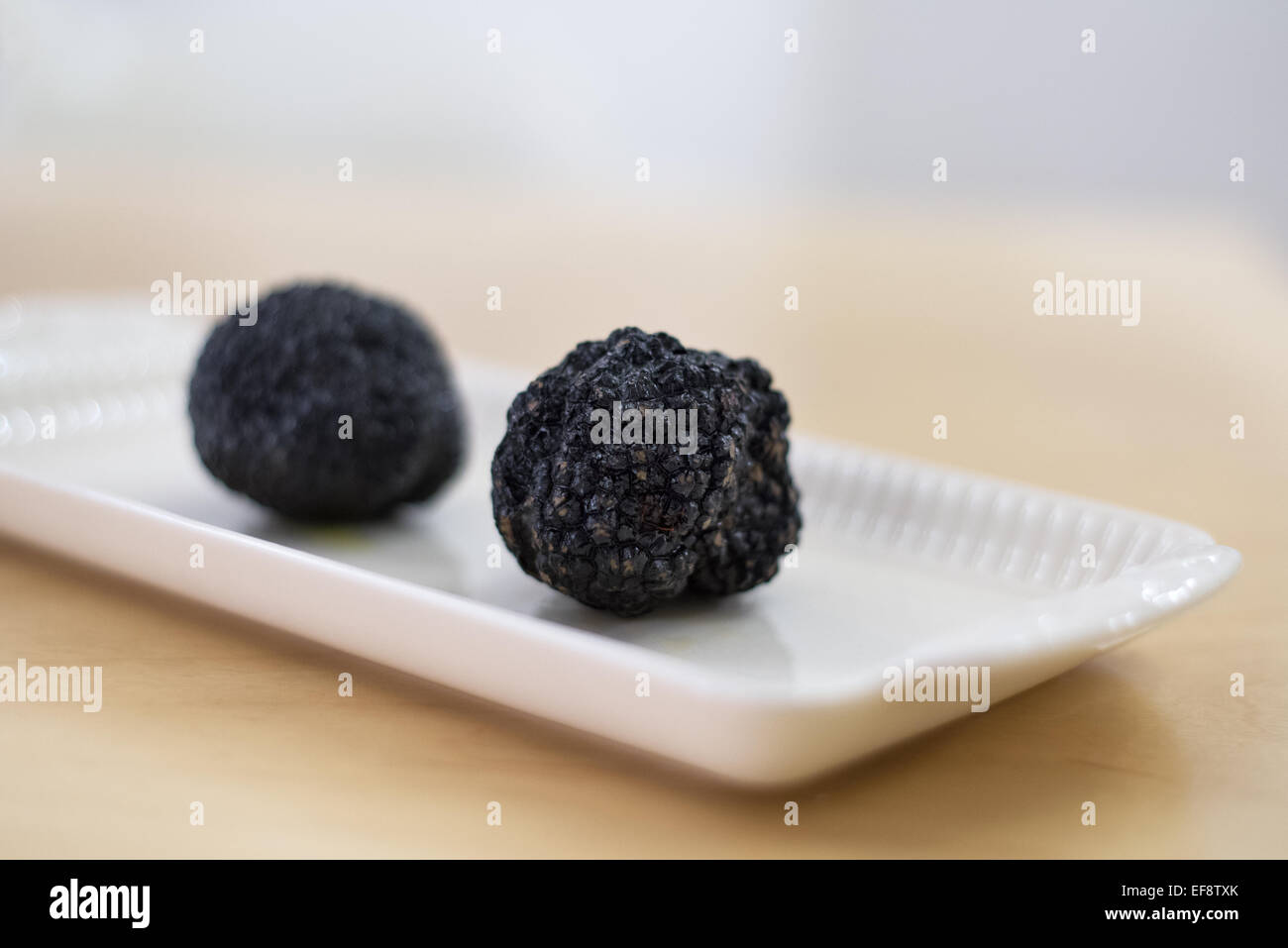 Two burgundy truffles on a plate Stock Photo