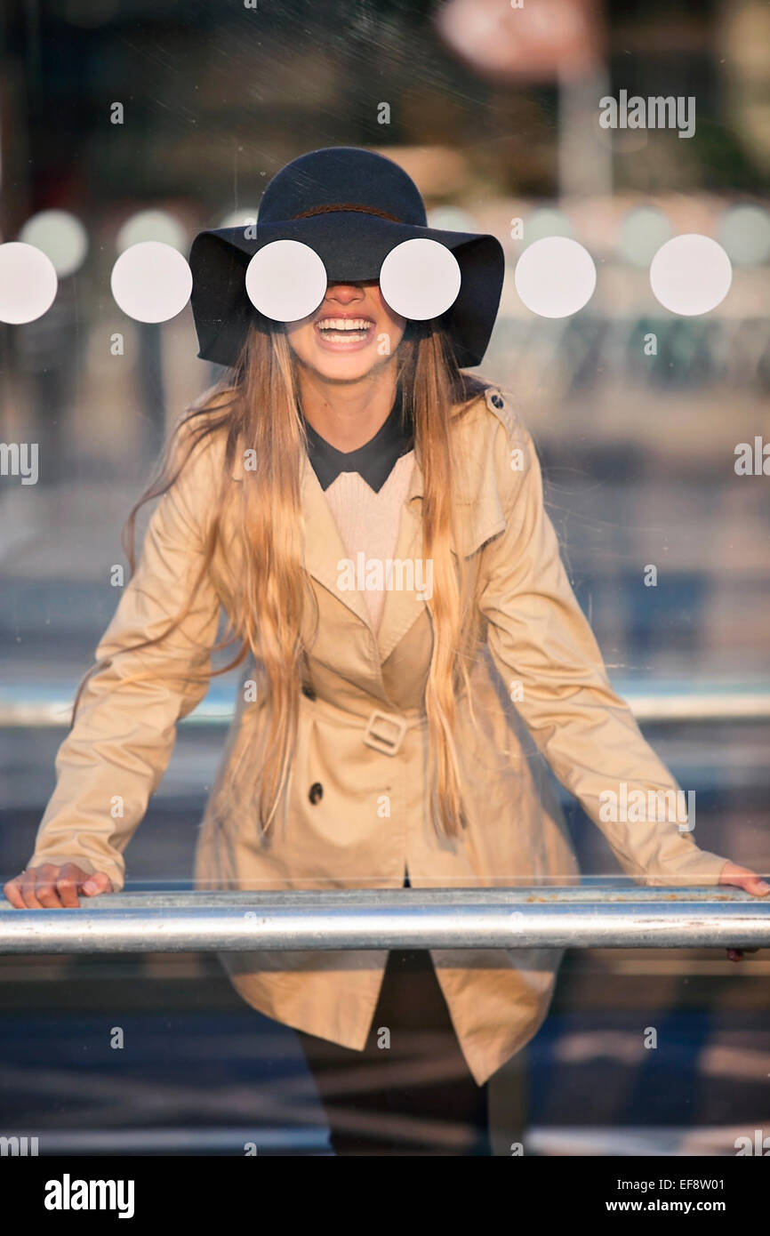 Smiling girl (12-13 )in hat seeing through bus stop Stock Photo