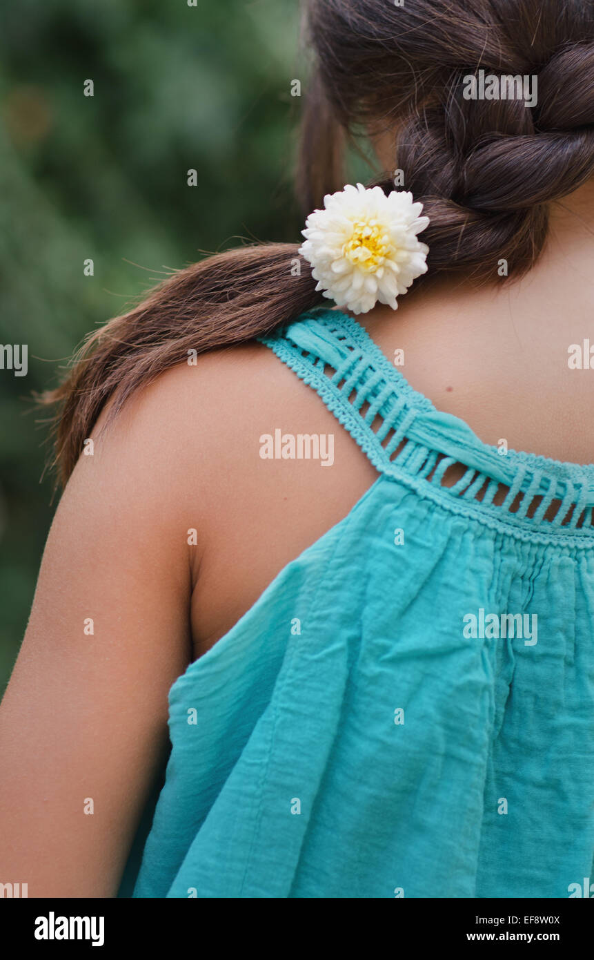 Close-up of girl's (10-11) braid with flower Stock Photo