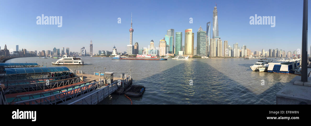 China, Shanghai, Pudong, Urban skyline with ferries in foreground Stock Photo