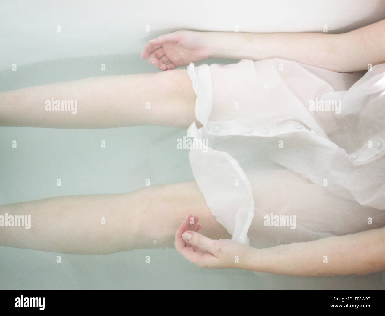 Pale girl in bathtub Stock Photo