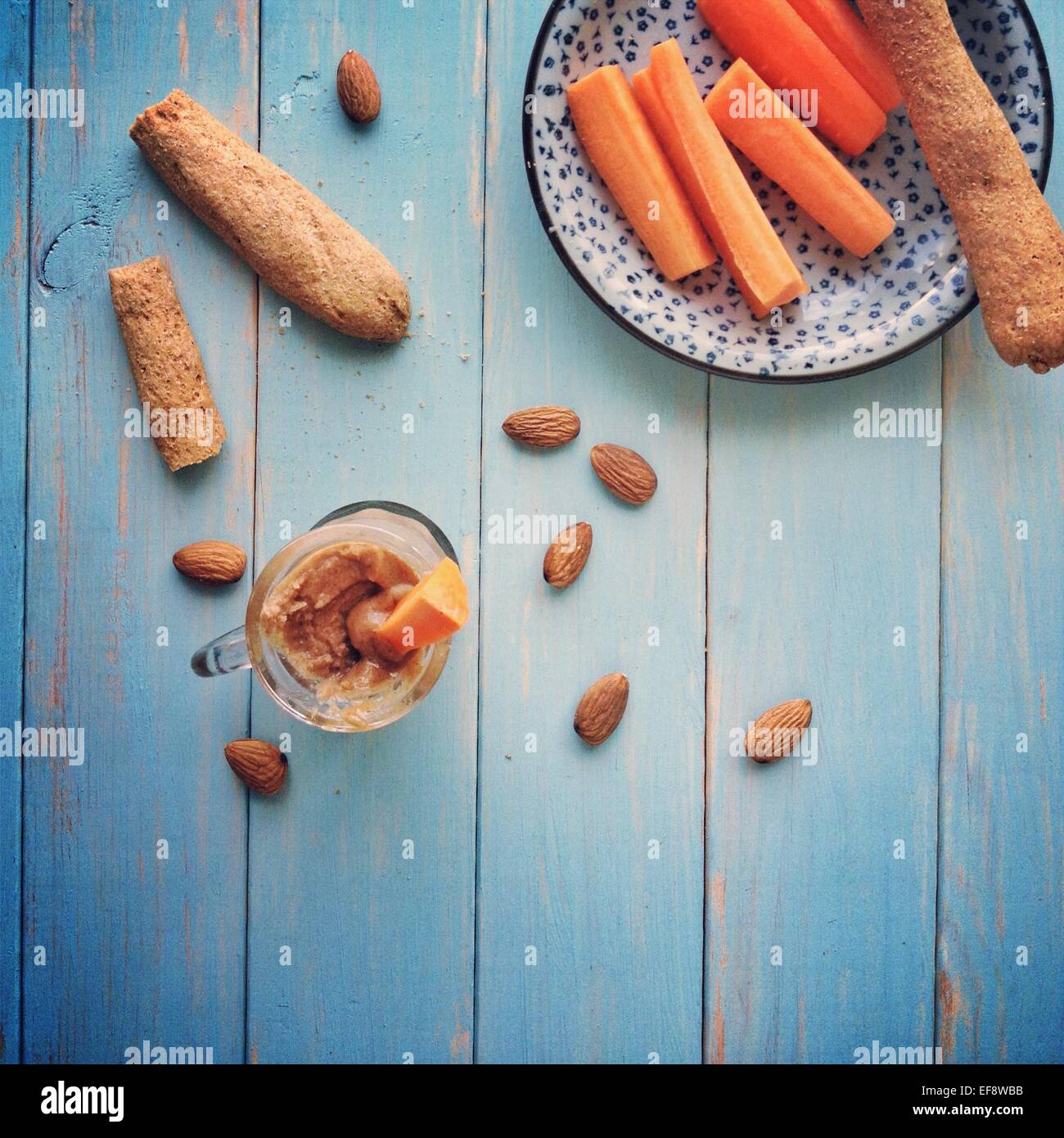 Carrots and breadsticks with homemade almond butter Stock Photo