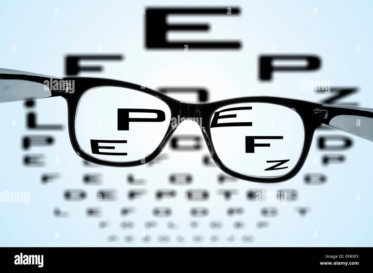 eyeglasses over a blurry eye chart Stock Photo