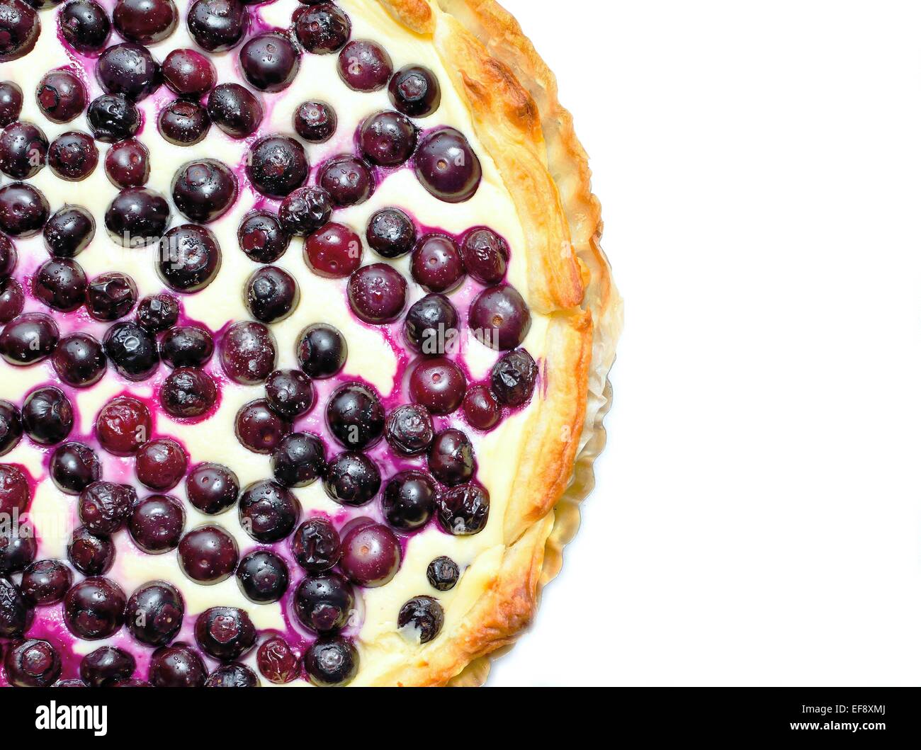 Top view on a blueberry cheese pie placed on a white background. Stock Photo