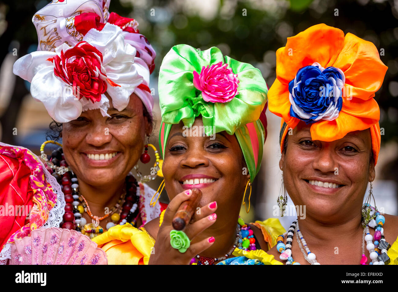 Three Cuban women in colorful Spanish-inspired costumes, Havana, Cuba Stock Photo