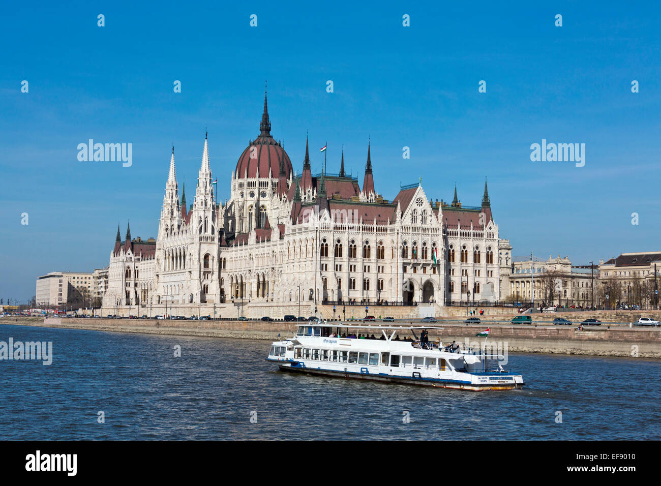 Hungarian Parliament Building from Buda side of Budapest, tourist boat, sunny day, blue sky , over Danube river. Hungary Stock Photo