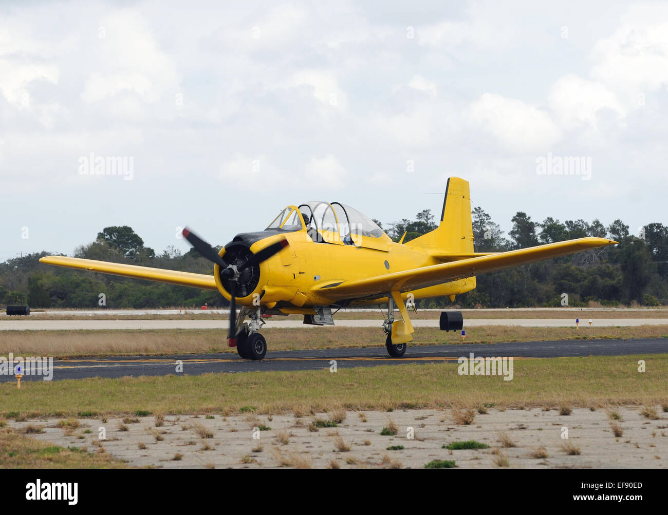 Vintage yellow airplane taxiing on the ground Stock Photo