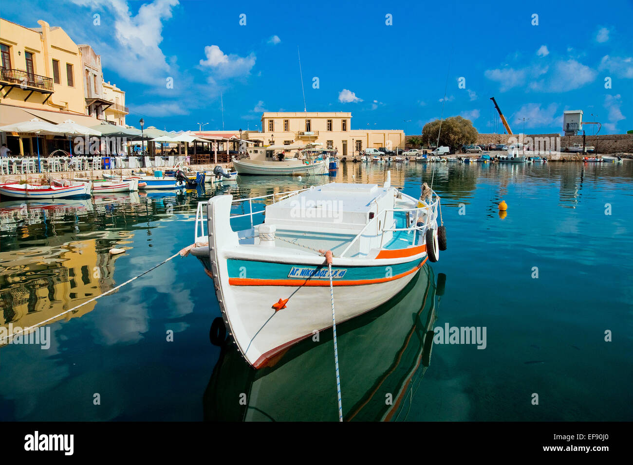 Brightly-painted traditional style boat moored in the old boat harbour at Rethymno, Crete Stock Photo