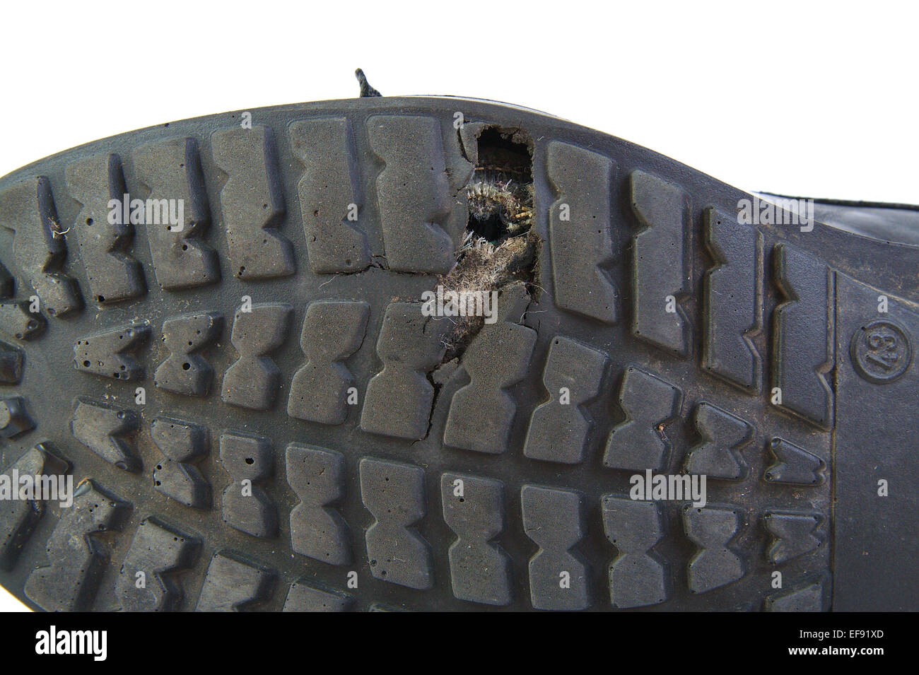 Black shoe with a hole in the sole isolated on white background Stock