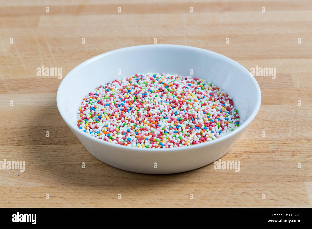 Love beads in a bowl on wood. Stock Photo