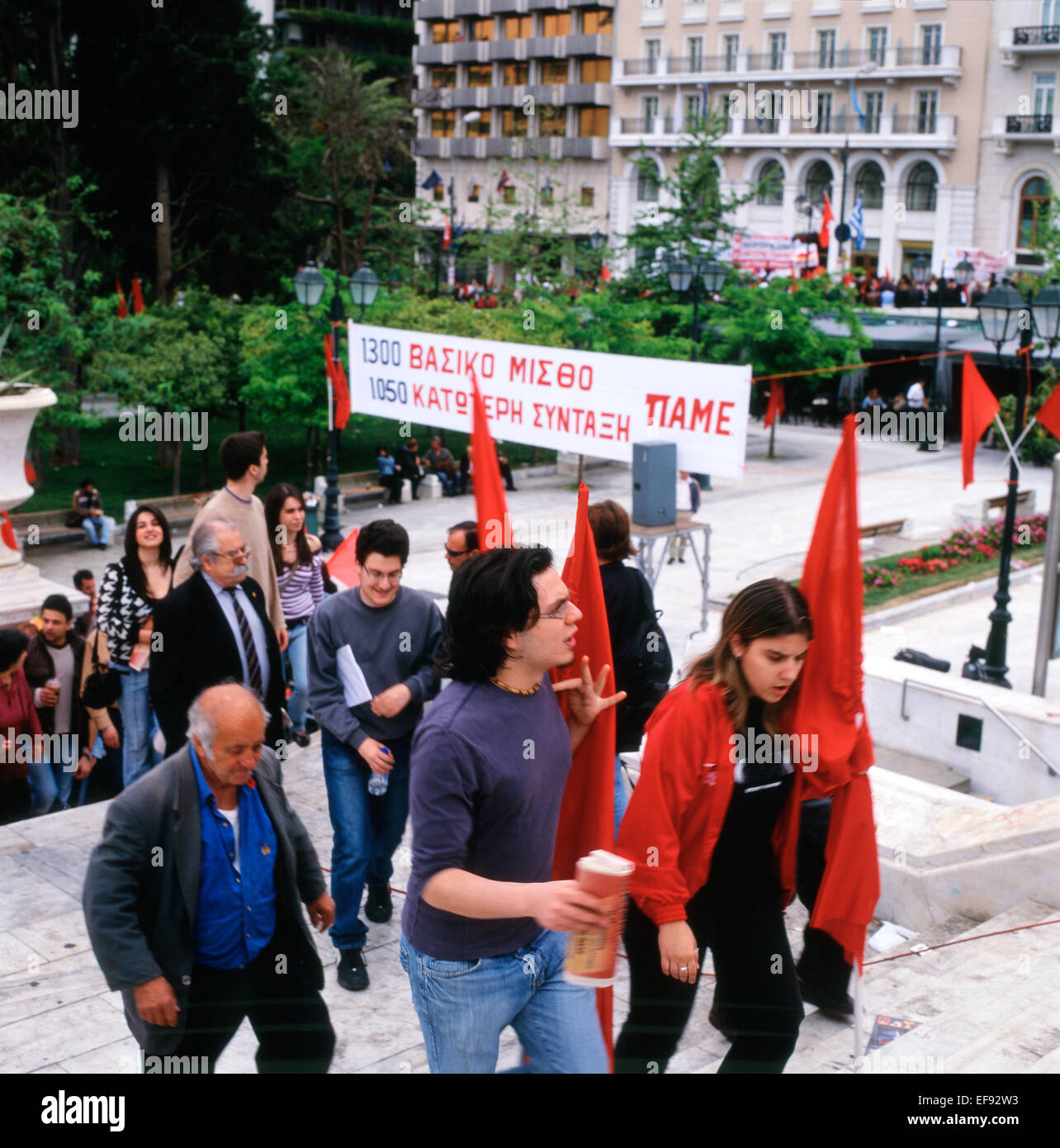 People at 1st May Day demonstration carrying banners and signs walking up the steps to Syntagma Square in Athens, Greece  KATHY DEWITT Stock Photo