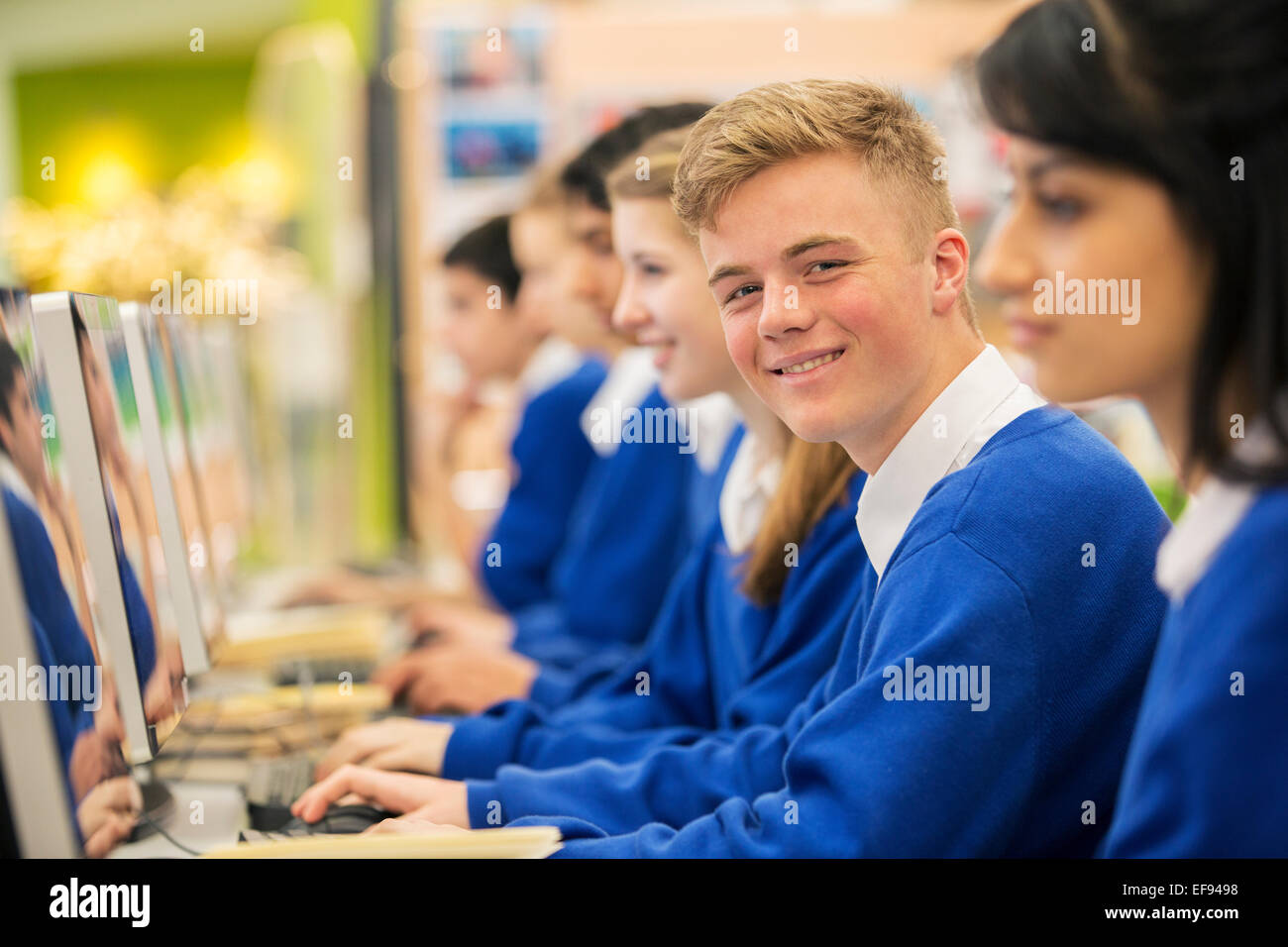 Happy students learning in computer room Stock Photo
