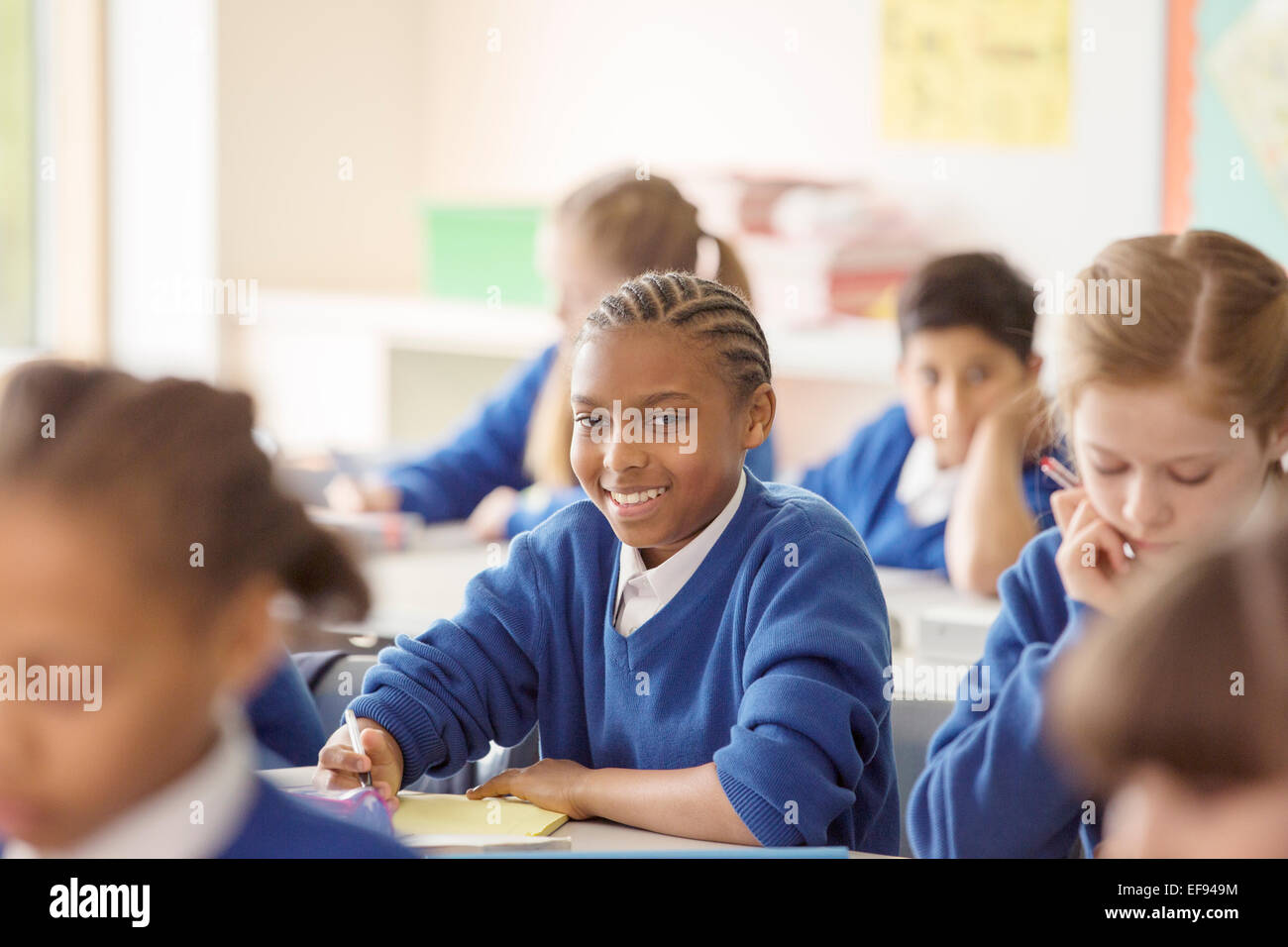 Portrait of schoolboy learning in classroom Stock Photo