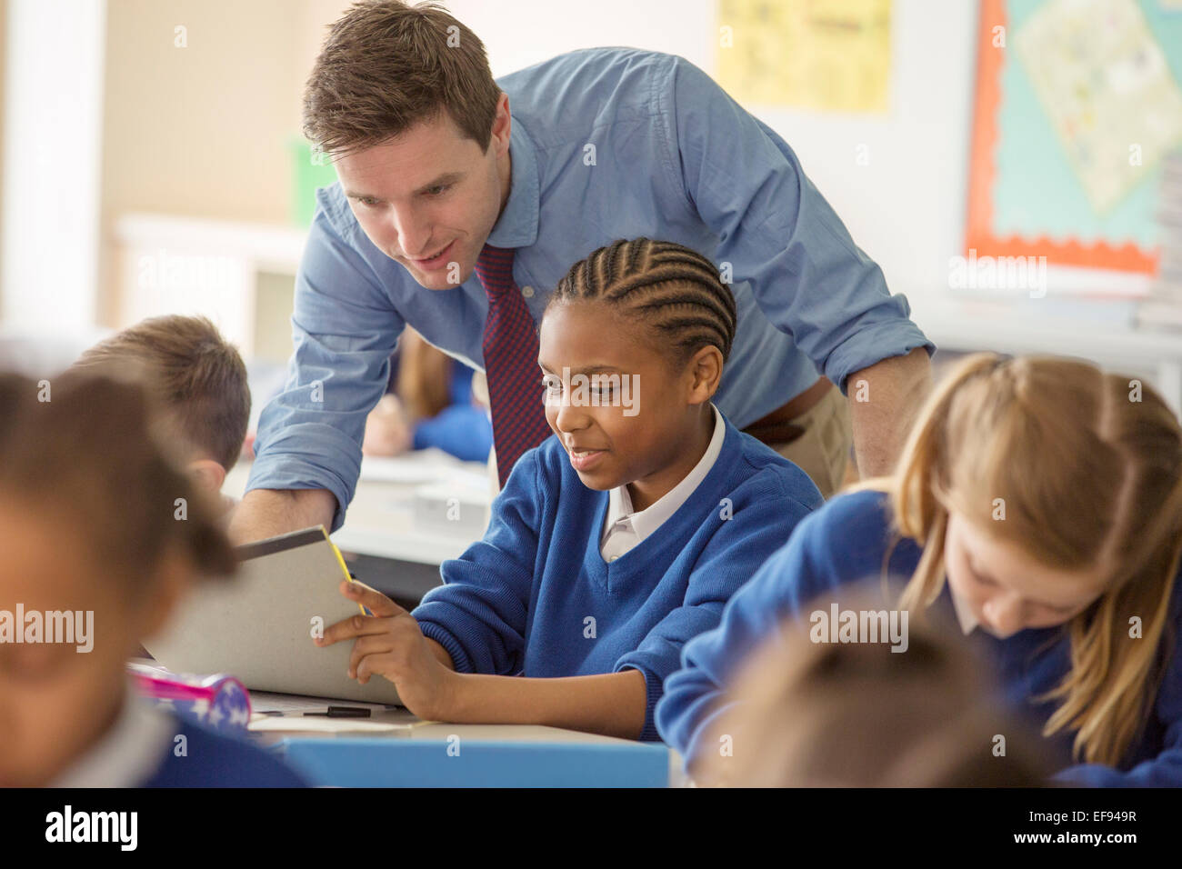 Teacher with his pupils in classroom Stock Photo