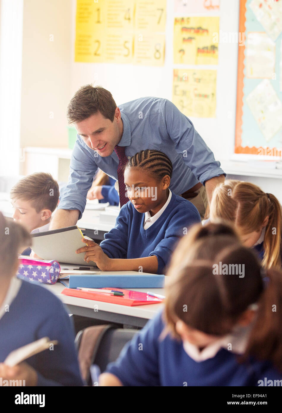 Teacher with his pupils in classroom Stock Photo