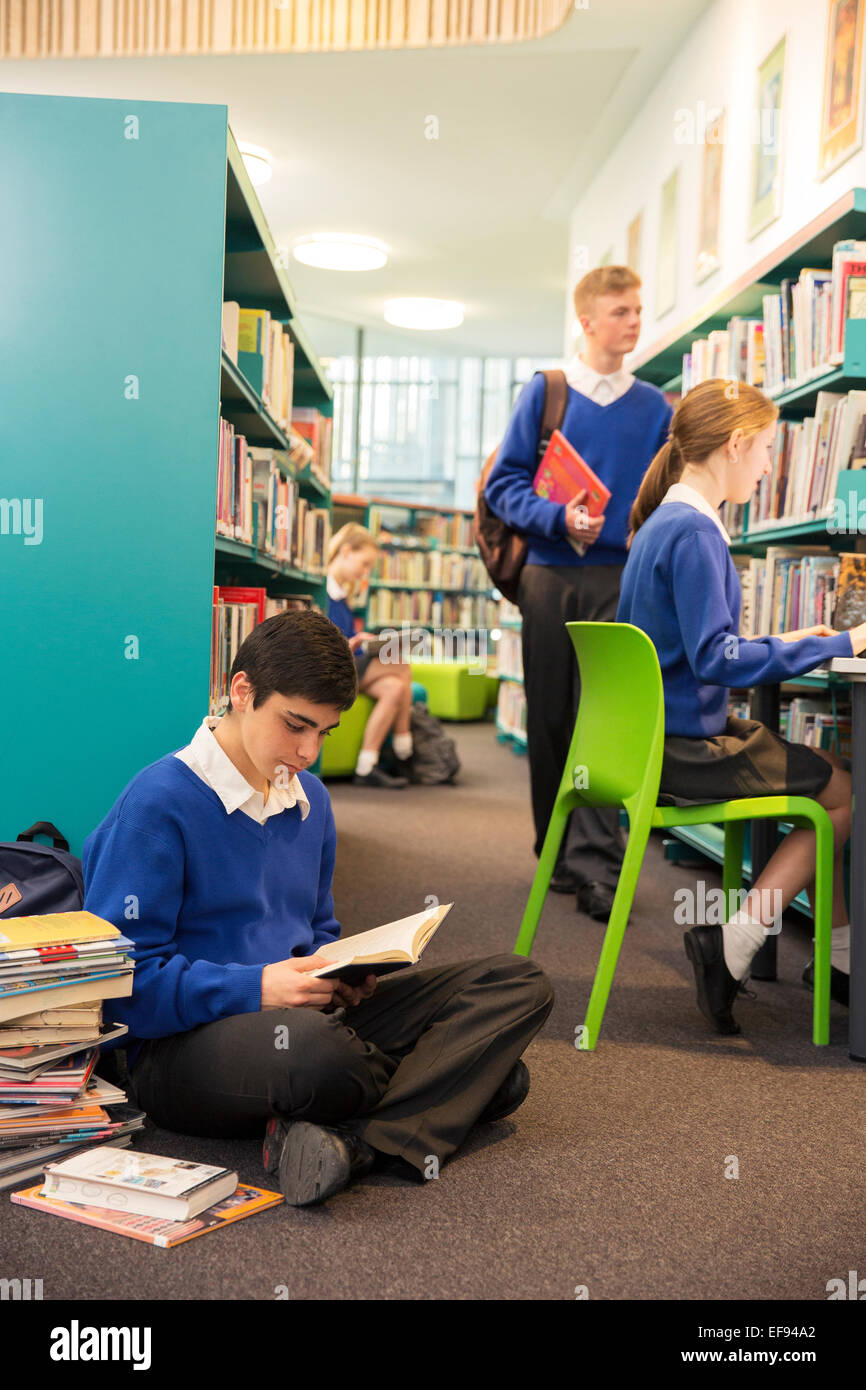 Teenage students learning in college library Stock Photo