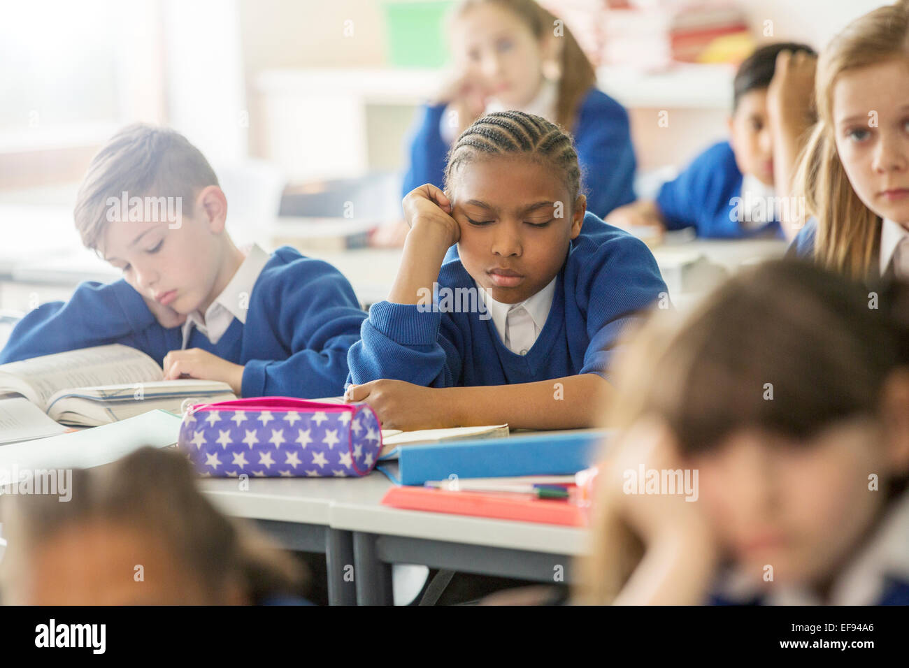 Elementary school children asleep and bored in classroom Stock Photo