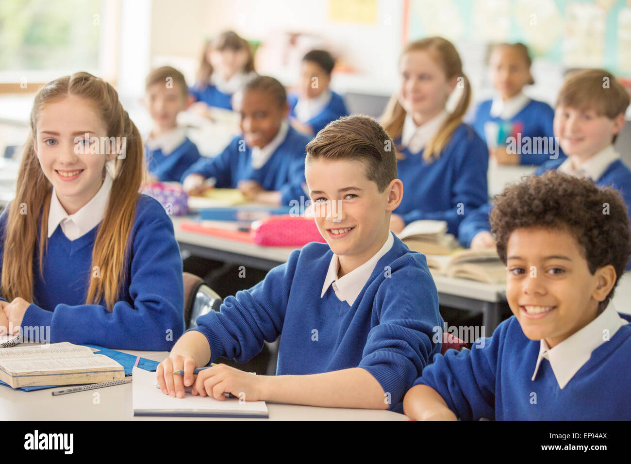 Elementary school children smiling in classroom Stock Photo