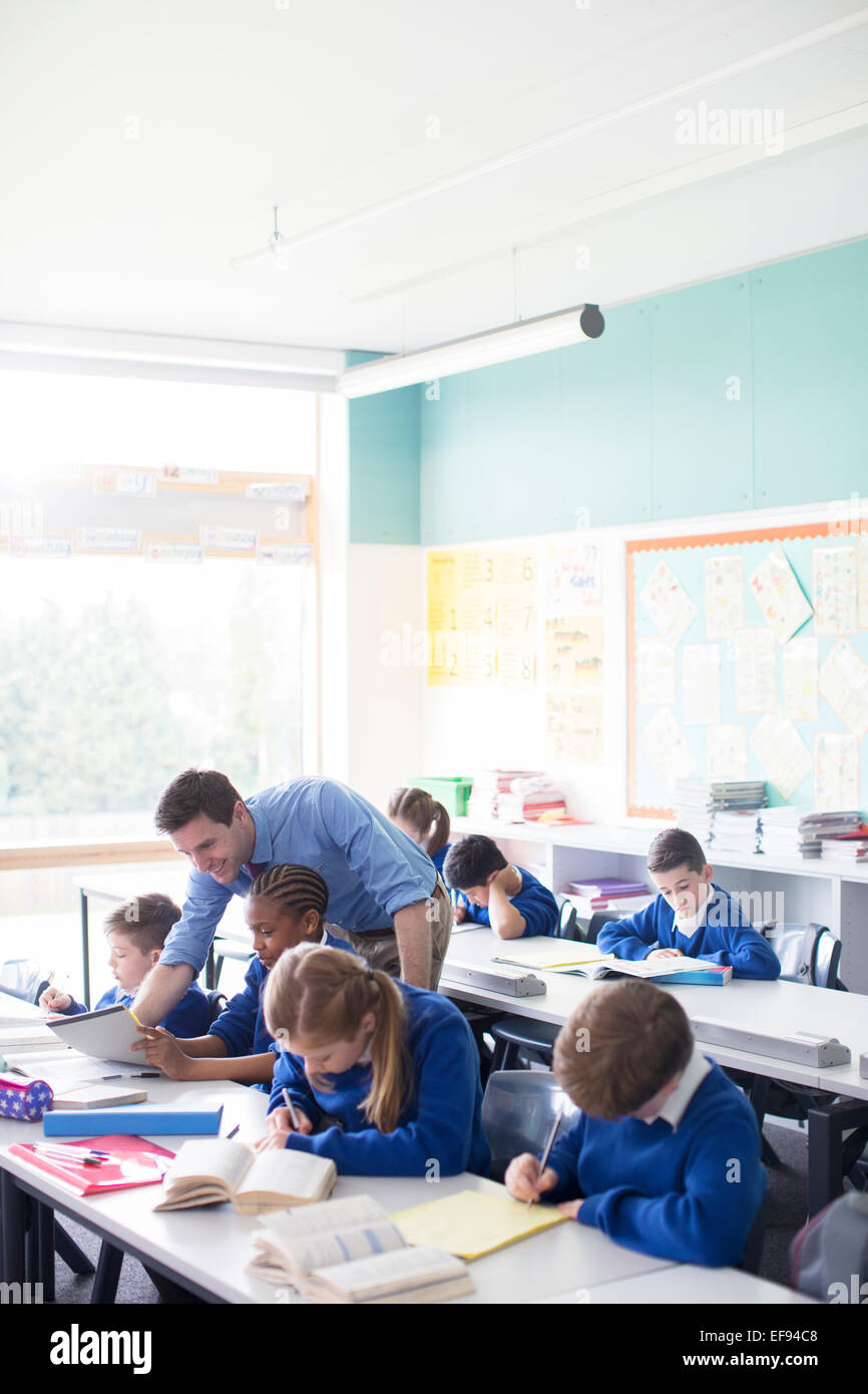 Teacher with his pupils in classroom Stock Photo - Alamy