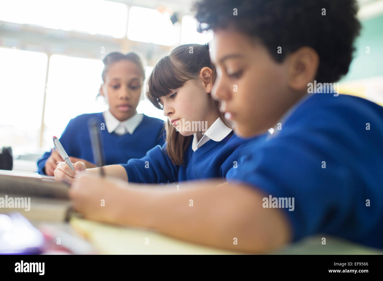 Schoolboys and schoolgirls learning in classroom Stock Photo