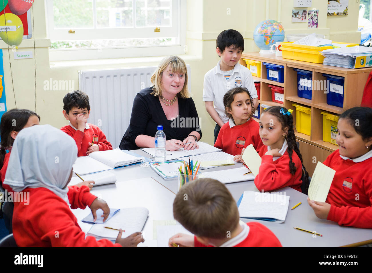 Teacher and children in class at  Primary School London W2 Stock Photo