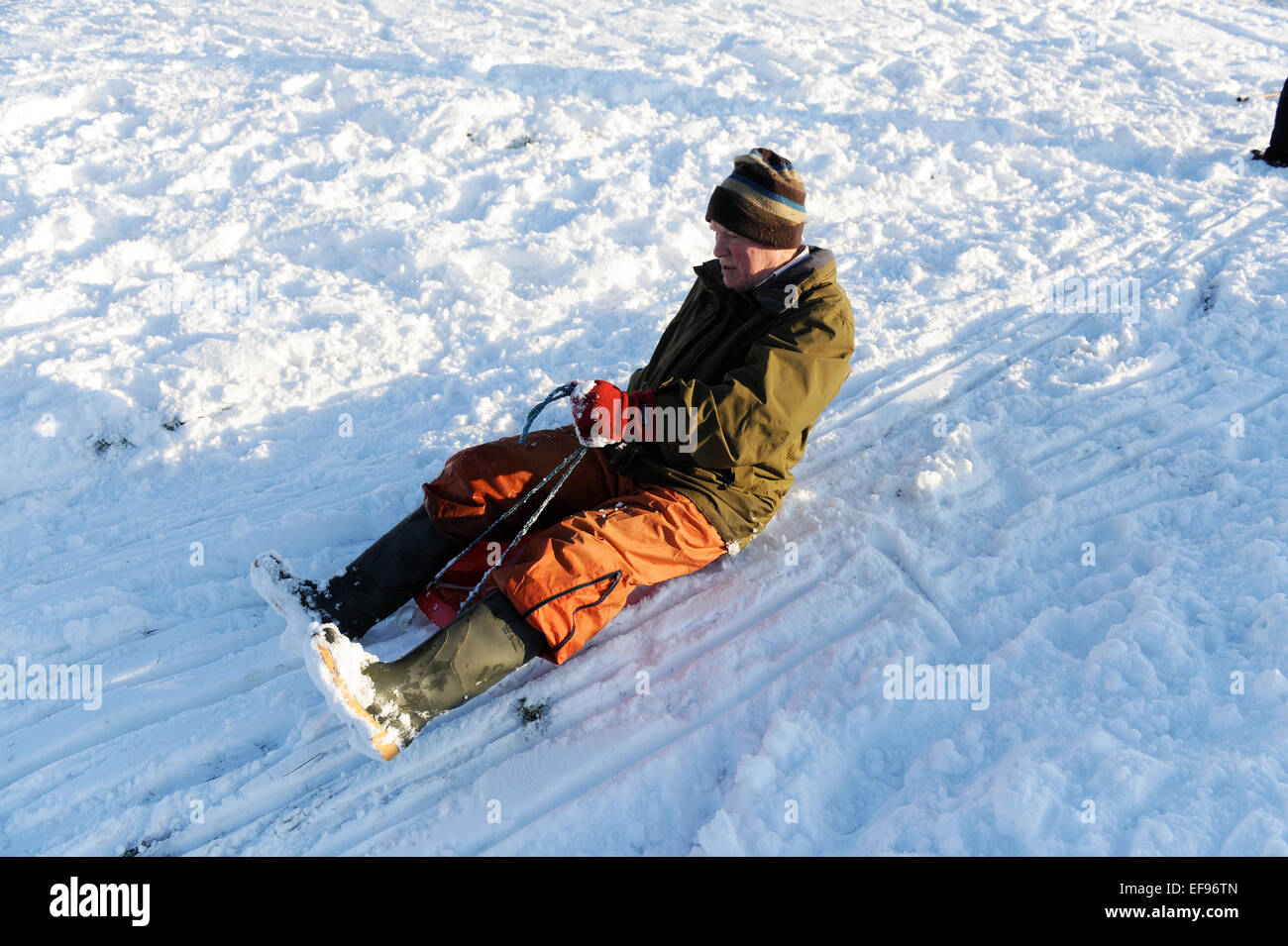 Pensioner aged 77 sledging in Bilsdale, North Yorkshire. Stock Photo