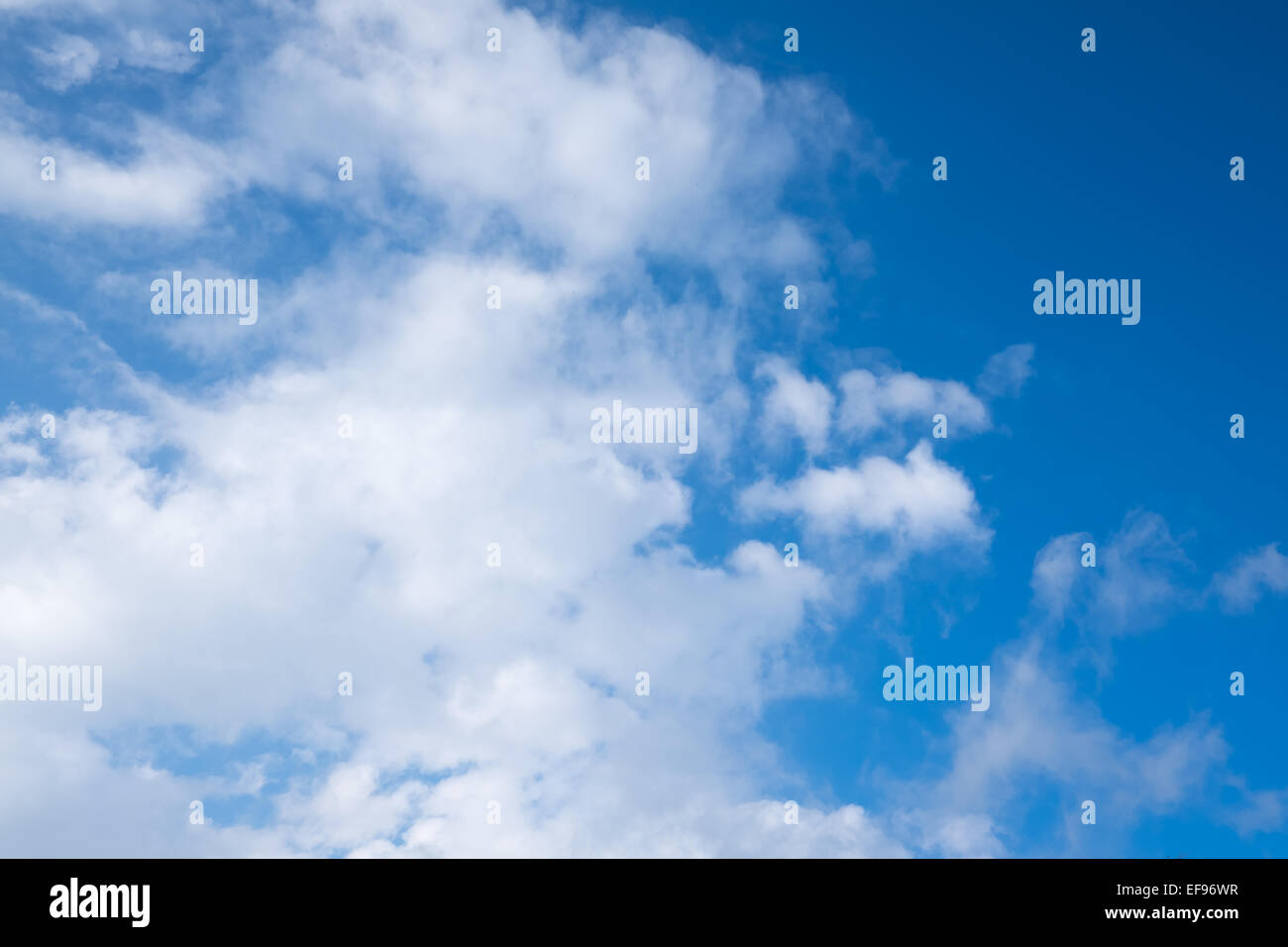 Blue sky with white fluffy clouds Stock Photo - Alamy