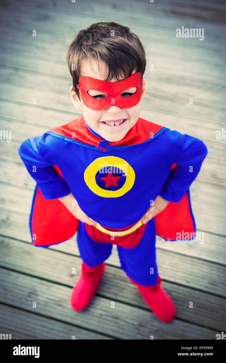 High angle view of superhero boy with hands on hips Stock Photo