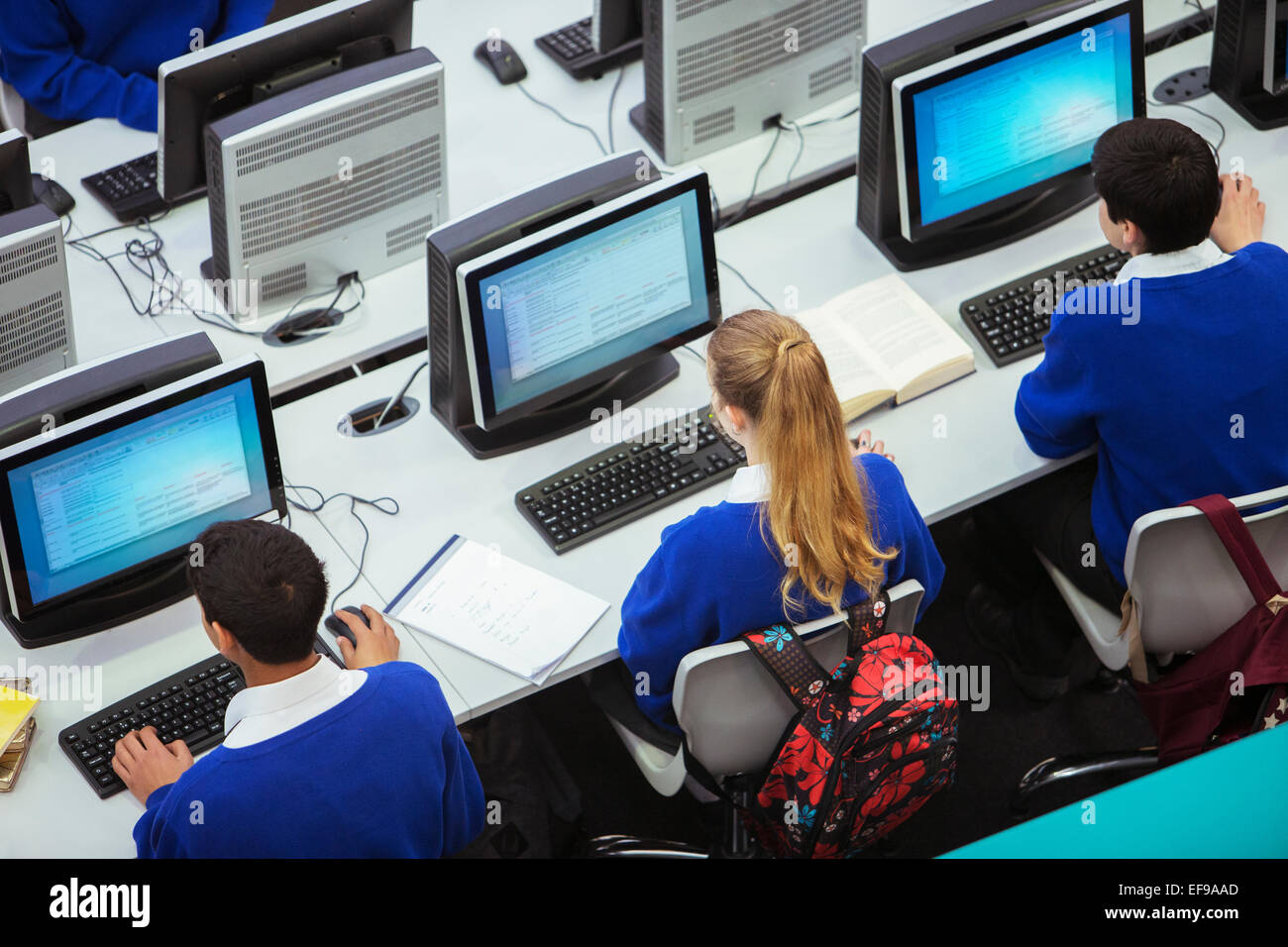 Elevated view of students sitting and learning in computer room Stock Photo