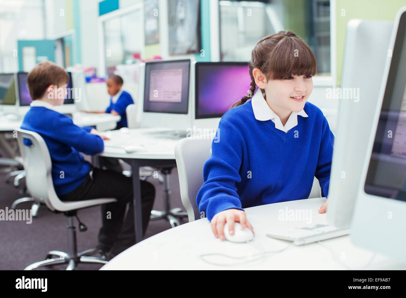 Primary school children working with computers during IT lesson Stock Photo