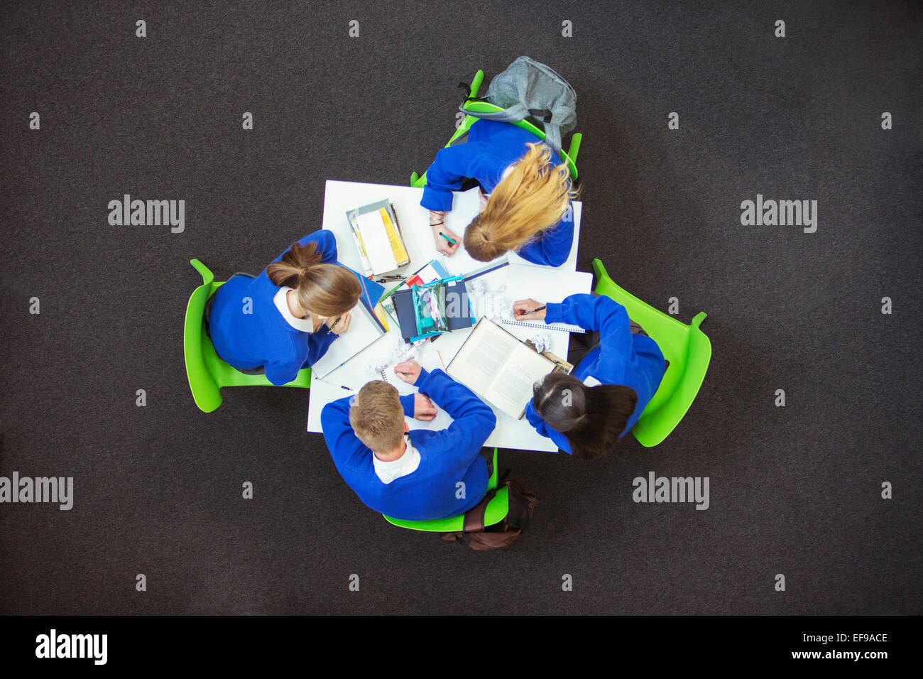 Overhead view of students doing their homework together Stock Photo